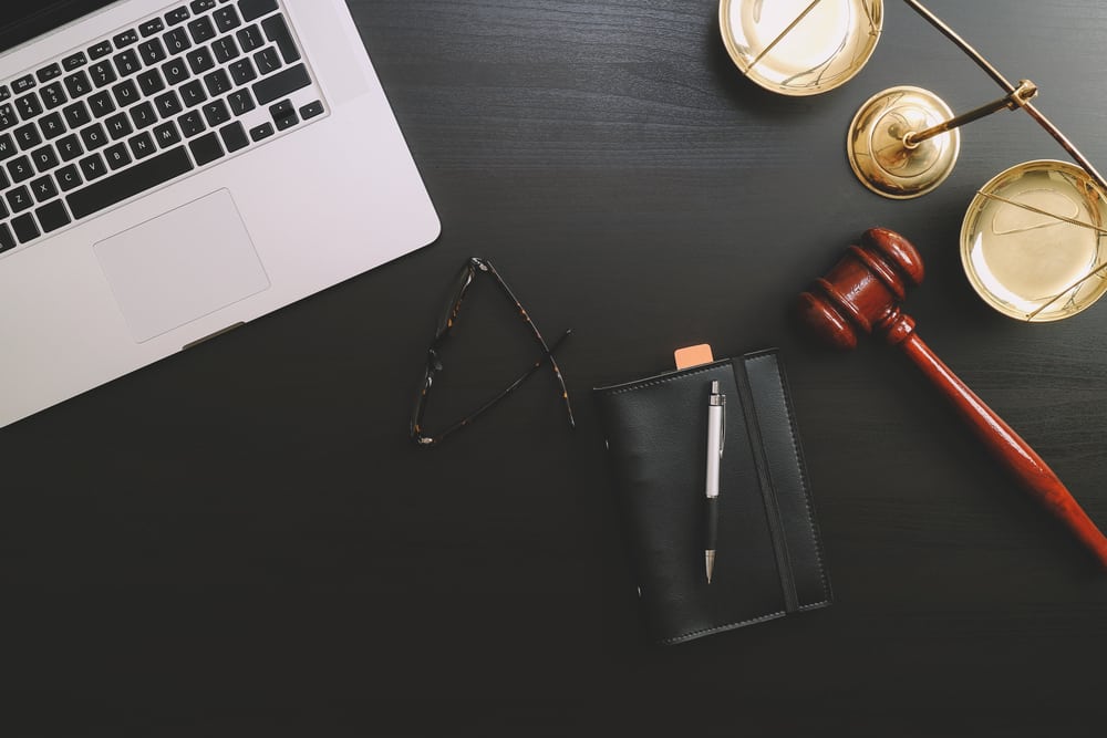 Attorney desk with laptop and gavel illustrating the issue of cybersecurity for the legal industry