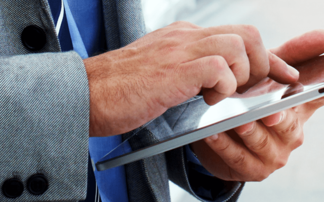 Businessman in gray suit and blue shirt using a secure mobile device