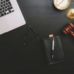 Attorney desk with laptop and gavel illustrating the issue of cybersecurity for the legal industry